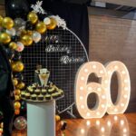 Mesh backdrop set up with number light and cake plinth