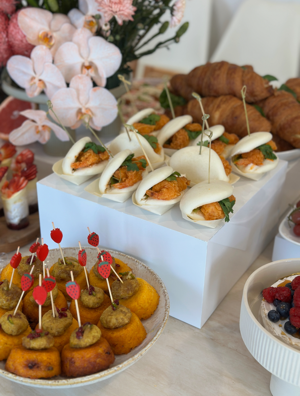 White buffet riser with food set up on display